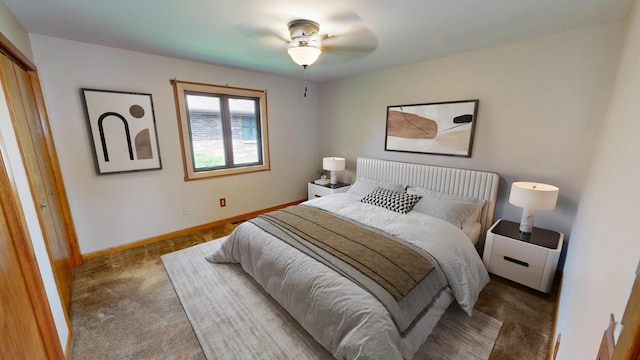 carpeted bedroom featuring baseboards and a closet