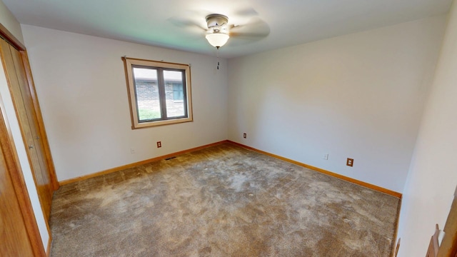spare room with baseboards, a ceiling fan, carpet flooring, and visible vents