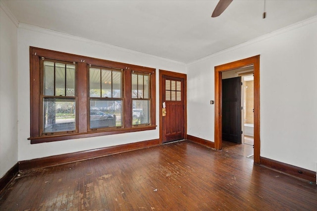 interior space featuring a ceiling fan, hardwood / wood-style floors, crown molding, and baseboards