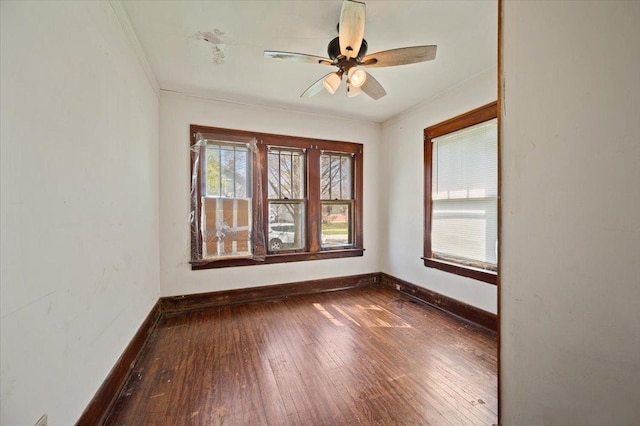 empty room with wood-type flooring, ceiling fan, and baseboards