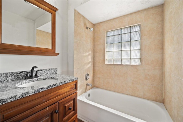 bathroom with vanity and bathtub / shower combination