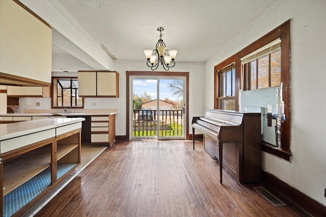 interior space featuring visible vents, a wealth of natural light, a chandelier, and dark wood finished floors