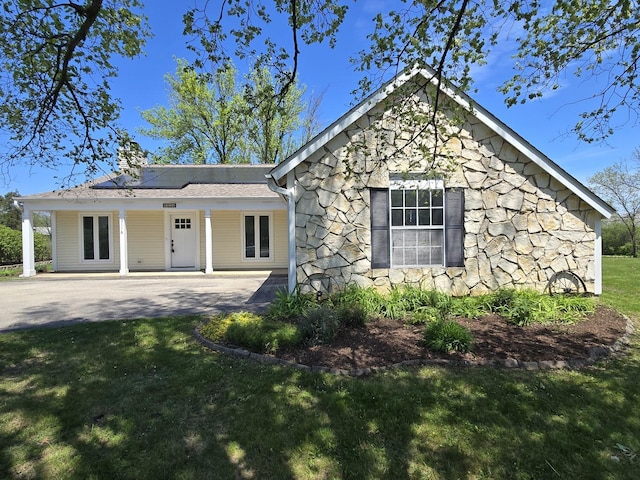5116 Beechwood Ave, Gurnee, IL 60031 - view of front facade with stone siding, a front lawn, roof mounted solar panels, and a chimney