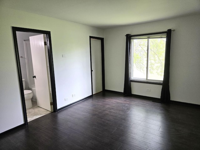 5116 Beechwood Ave, Gurnee, IL 60031 - unfurnished bedroom with wood finished floors, connected bathroom, and baseboards