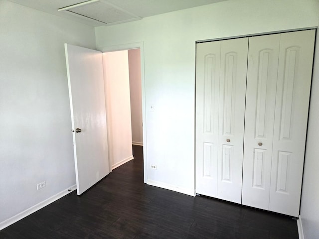 5116 Beechwood Ave, Gurnee, IL 60031 - unfurnished bedroom with dark wood-style flooring, baseboards, a closet, and attic access