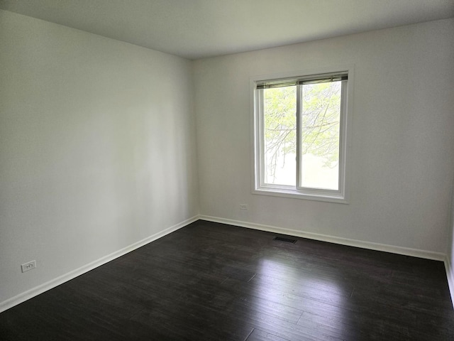 5116 Beechwood Ave, Gurnee, IL 60031 - spare room featuring baseboards and dark wood-type flooring