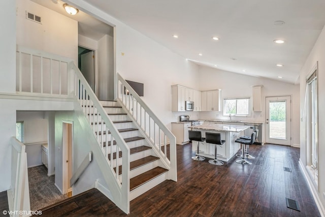 5116 Beechwood Ave, Gurnee, IL 60031 - staircase featuring wood finished floors, recessed lighting, high vaulted ceiling, and baseboards