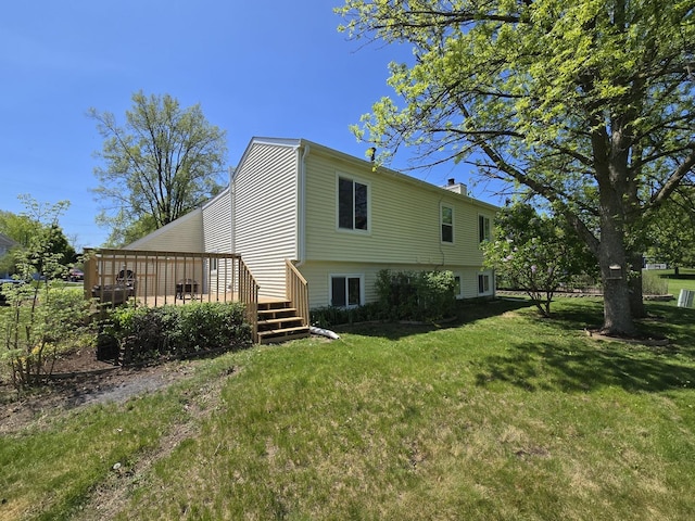 5116 Beechwood Ave, Gurnee, IL 60031 - rear view of house with a chimney, a yard, and a deck