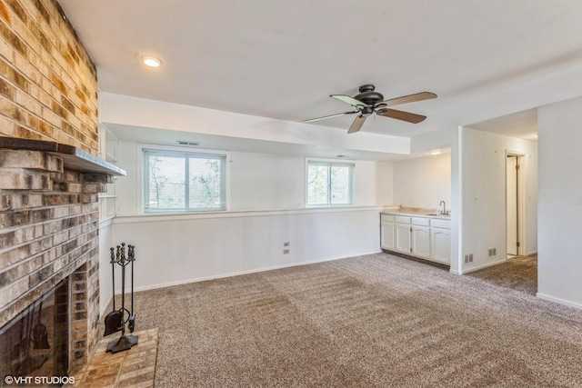 5116 Beechwood Ave, Gurnee, IL 60031 - unfurnished living room featuring a sink, carpet floors, a ceiling fan, a fireplace, and baseboards