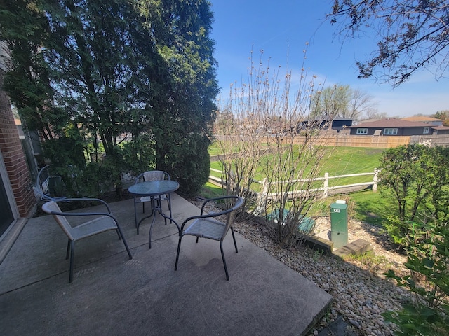 view of patio / terrace featuring fence