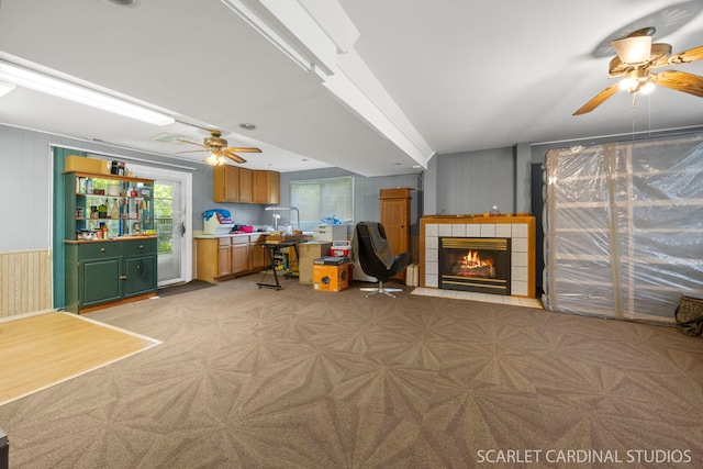 212 S River Rd, Naperville, IL 60540 - living room with ceiling fan, a tiled fireplace, and light colored carpet