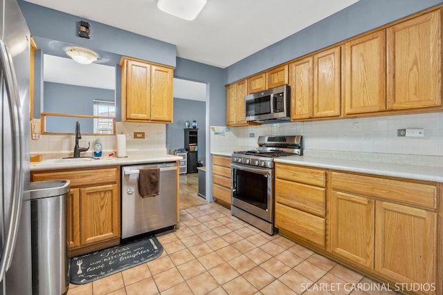 212 S River Rd, Naperville, IL 60540 - kitchen with stainless steel appliances, a sink, backsplash, light countertops, and light tile patterned floors