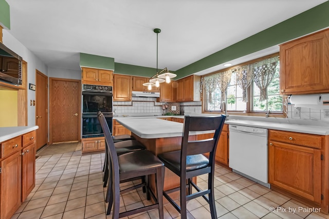 3518 James Way, Johnsburg, IL 60051 - kitchen featuring tasteful backsplash, dobule oven black, light countertops, and white dishwasher
