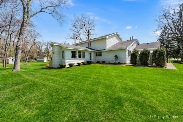 3518 James Way, Johnsburg, IL 60051 - back of house with roof with shingles and a yard
