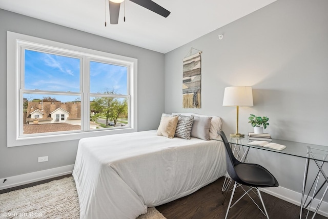 bedroom with baseboards, a ceiling fan, and wood finished floors