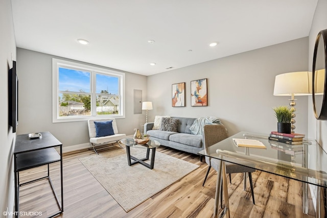 living area with light wood finished floors, baseboards, and recessed lighting