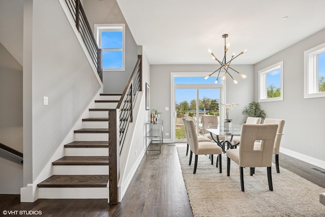 dining area featuring a chandelier, dark wood-type flooring, baseboards, and stairs