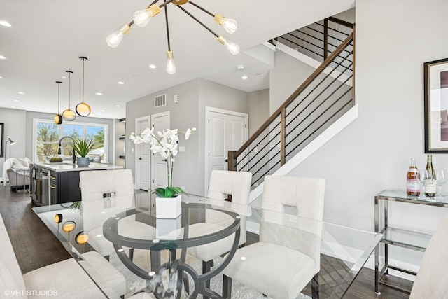 dining room with dark wood-style flooring, stairs, visible vents, and recessed lighting