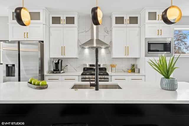 kitchen with white cabinetry, appliances with stainless steel finishes, and backsplash