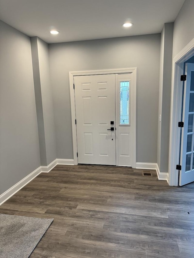 entrance foyer with baseboards, wood finished floors, visible vents, and recessed lighting