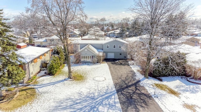 snowy aerial view with a residential view
