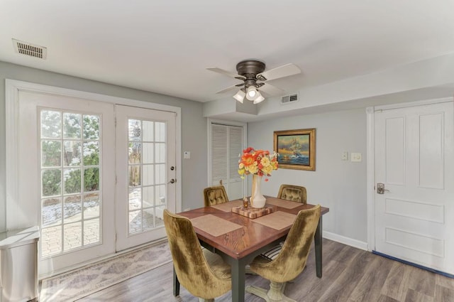 dining room featuring a ceiling fan, wood finished floors, and visible vents