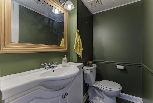 bathroom featuring visible vents, toilet, and vanity