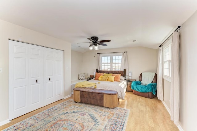 bedroom featuring ceiling fan, baseboards, a closet, and light wood-type flooring