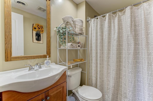 bathroom featuring a shower with curtain, visible vents, vanity, and toilet