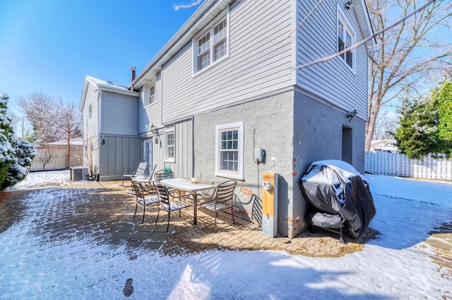 back of property with stucco siding, cooling unit, fence, and a patio