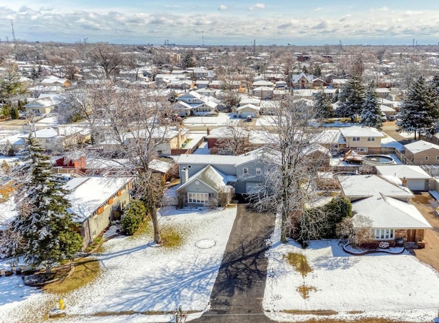 snowy aerial view featuring a residential view