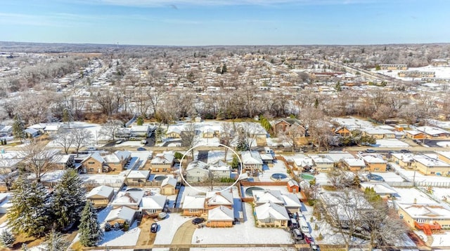 snowy aerial view featuring a residential view