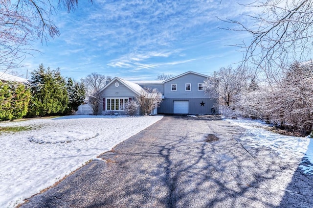 view of front facade featuring an attached garage and aphalt driveway