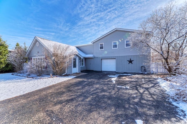 view of front facade with an attached garage and aphalt driveway