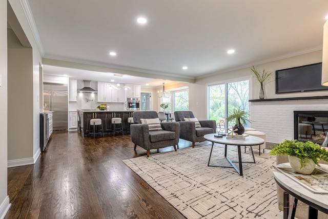 living area featuring a fireplace, baseboards, dark wood-style floors, ornamental molding, and recessed lighting