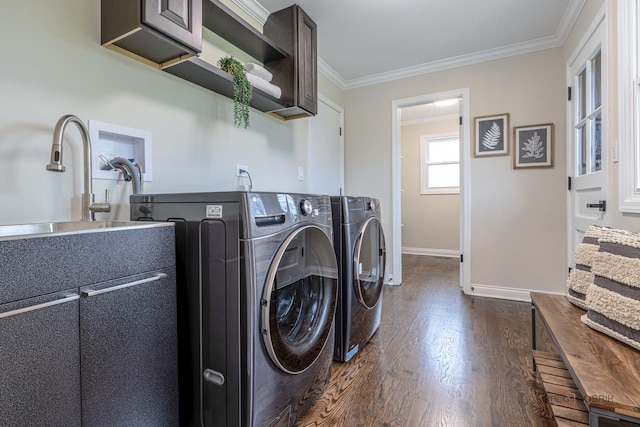 washroom with cabinet space, dark wood-style flooring, crown molding, washer and dryer, and baseboards