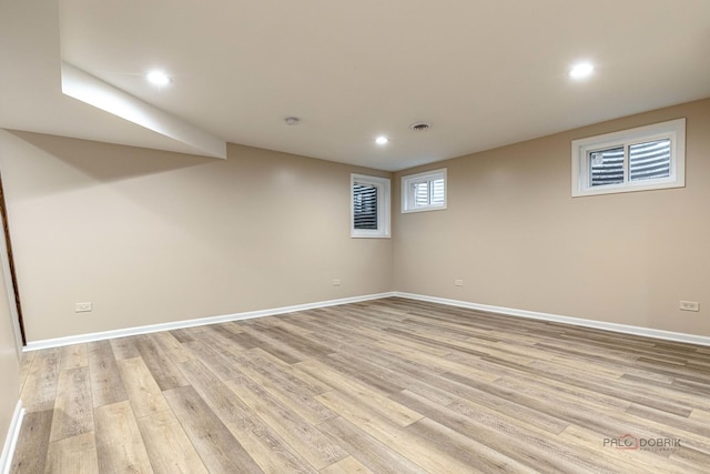 basement with recessed lighting, baseboards, and light wood-type flooring