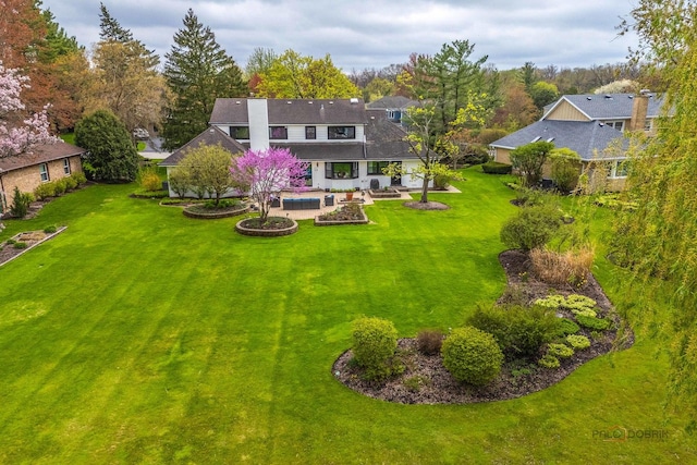 back of house with a patio, a yard, and a pool