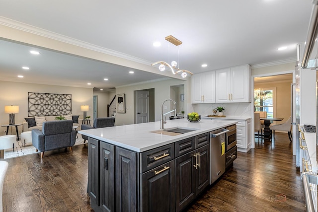 kitchen featuring stainless steel dishwasher, a sink, dark wood-style flooring, and white cabinets