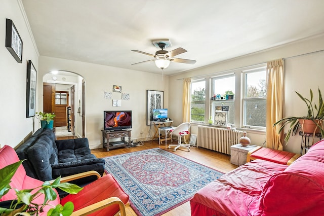 1127 Lathrop Ave, Forest Park, IL 60130 - living area with wood finished floors, baseboards, ceiling fan, radiator heating unit, and arched walkways