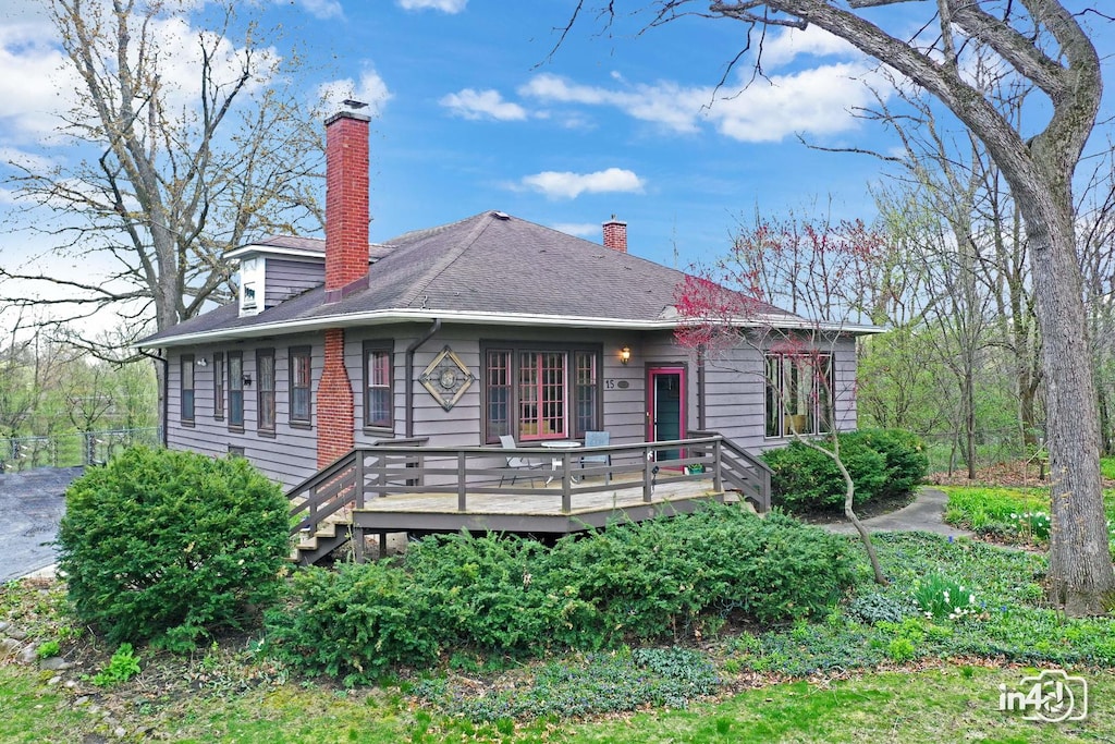 15 High Lake Ave, West Chicago, IL 60185 - view of front of property featuring a chimney, a shingled roof, and a wooden deck