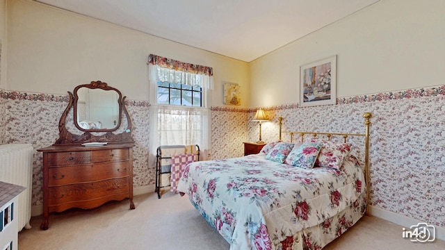 bedroom featuring wainscoting, wallpapered walls, carpet, vaulted ceiling, and radiator heating unit