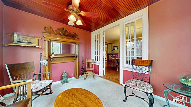 living area featuring wooden ceiling, baseboards, carpet floors, french doors, and a ceiling fan