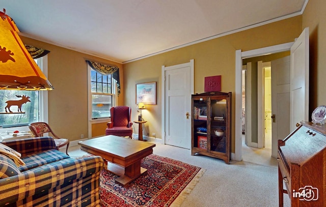 sitting room featuring baseboards, ornamental molding, and light colored carpet