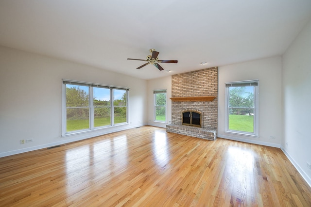 802 Ridgelawn Trl, Batavia, IL 60510 - unfurnished living room with plenty of natural light, a ceiling fan, wood finished floors, and baseboards