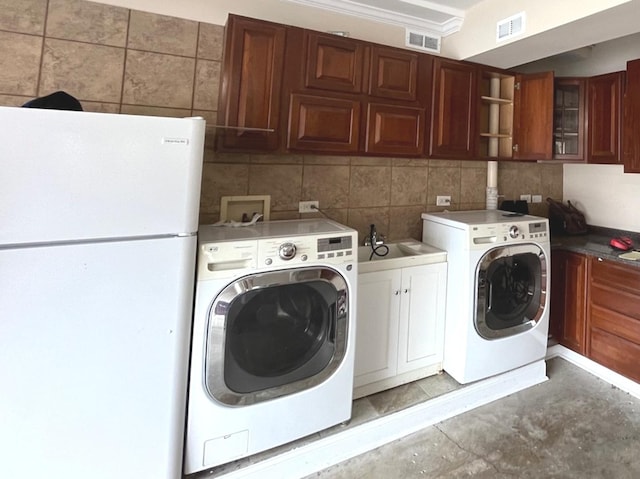 washroom featuring cabinet space, visible vents, hookup for a washing machine, and a sink