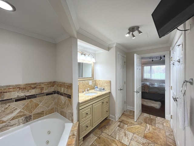 full bath featuring stone tile flooring, baseboards, a tub with jets, connected bathroom, and ornamental molding