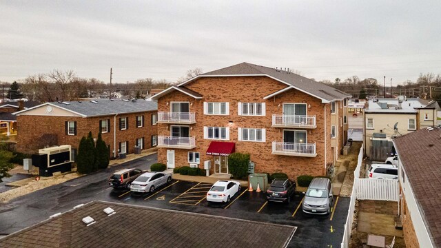 view of building exterior featuring uncovered parking