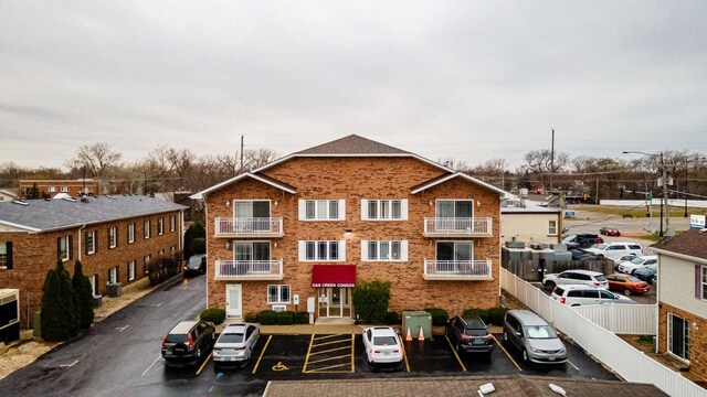 view of building exterior featuring uncovered parking