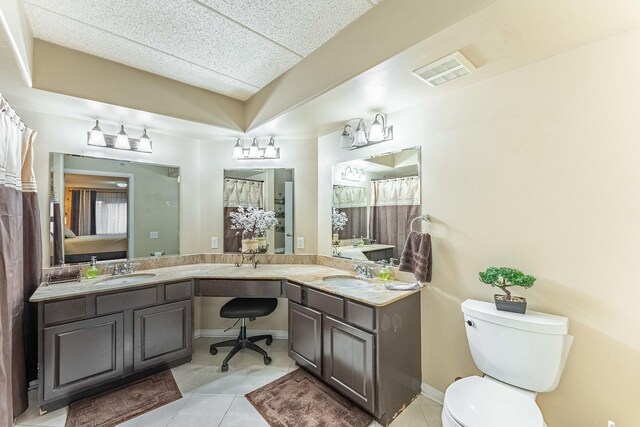 bathroom with toilet, tile patterned flooring, a sink, and visible vents